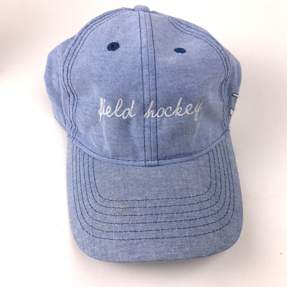 Field Hockey in script on light blue cap